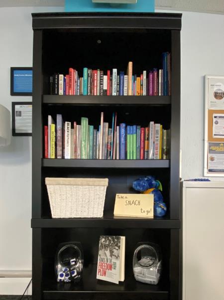 A Black bookshelf with colorful book spines